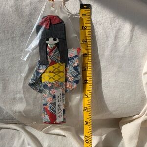 Traditional Japanese Doll with Red and Yellow Kimono